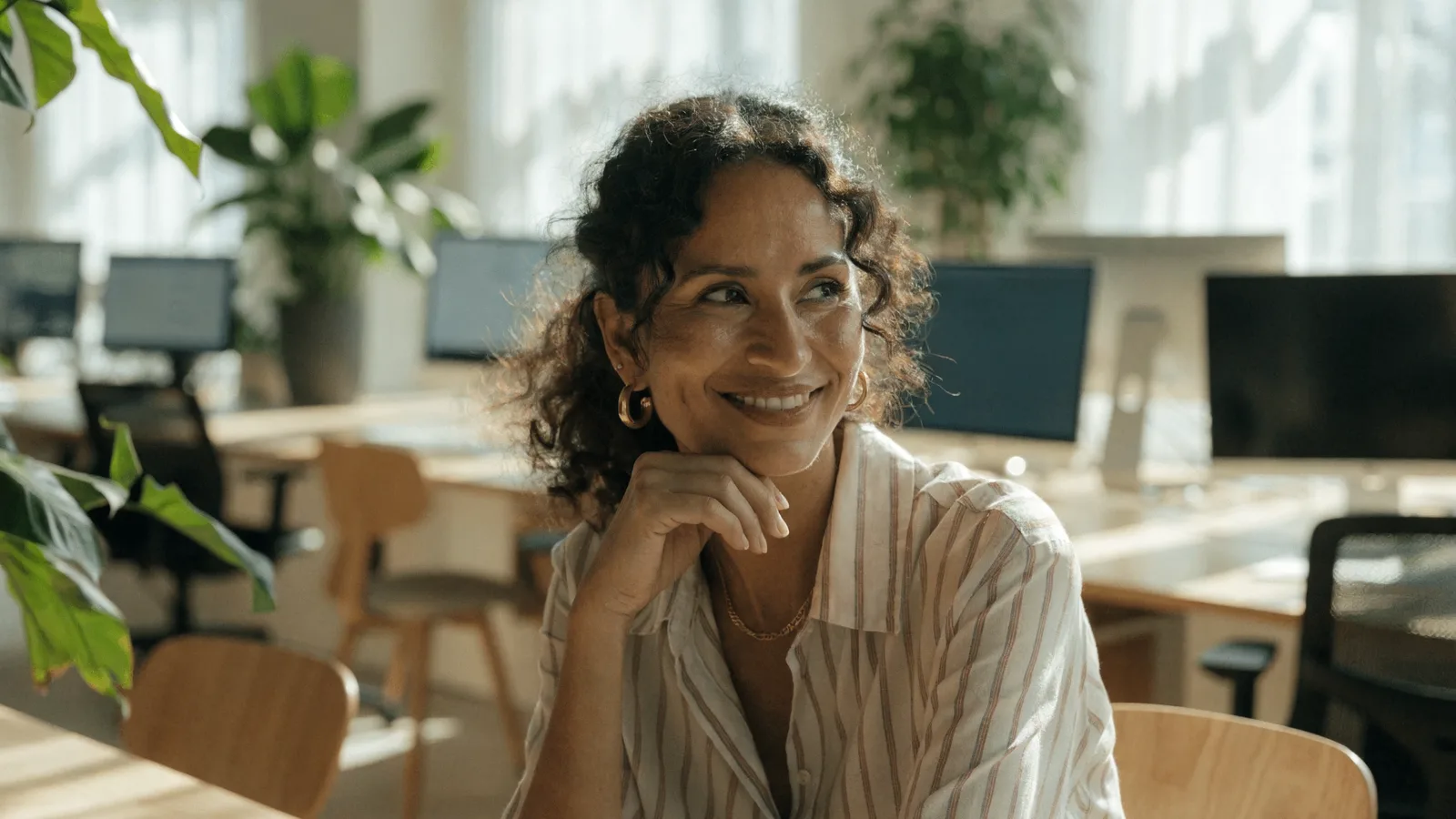 Photo of a concerned pest-control office manager on a desk phone fielding a cancellation call beside stacks of customer account paperwork, reducing churn